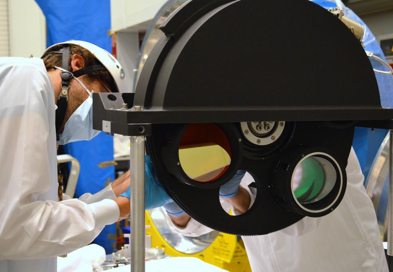 View of an engineer working on the grism wheel of EMIR at the laboratory