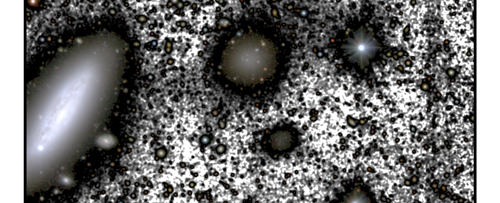 This image presents the region around the galaxy NGC 1052-DF4, taken by the IAC80 telescope at the Teide Observatory in Tenerife. The figure highlights the main galaxies in the field-of-view, including NGC 1052-DF4 (center of the image), and its neighbor NGC 1035 (center left). This image presents the region around the galaxy NGC 1052-DF4, taken by the IAC80 telescope at the Teide Observatory in Tenerife. The figure highlights the main galaxies in the field-of-view, including NGC 1052-DF4 (center of the image), and its neighbor NGC 1035 (center left).