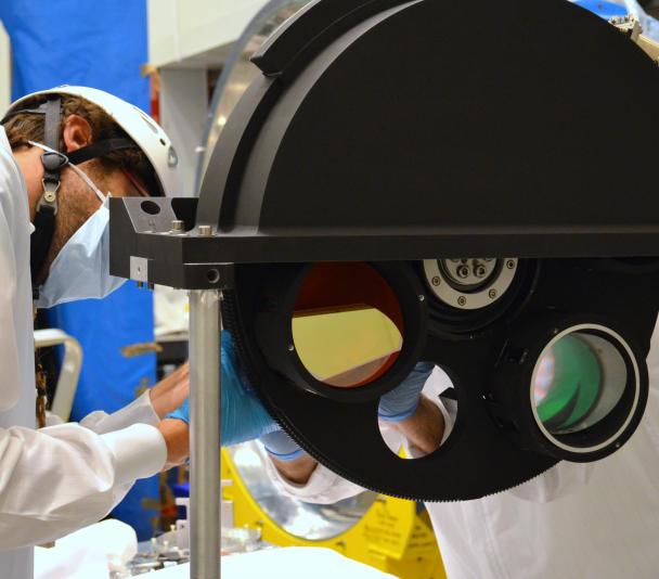 View of an engineer working on the grism wheel of EMIR at the laboratory