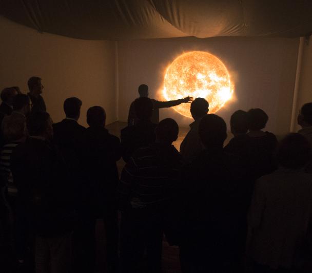 Visitors to the "Lights of the Universe" exhibition in front of the interactive module "Solar Immersion" on the upper floor of the Art Gallery of the Institute of the Canaries, Cabrera Pinto (La Laguna). Credits: Daniel López/IAC 