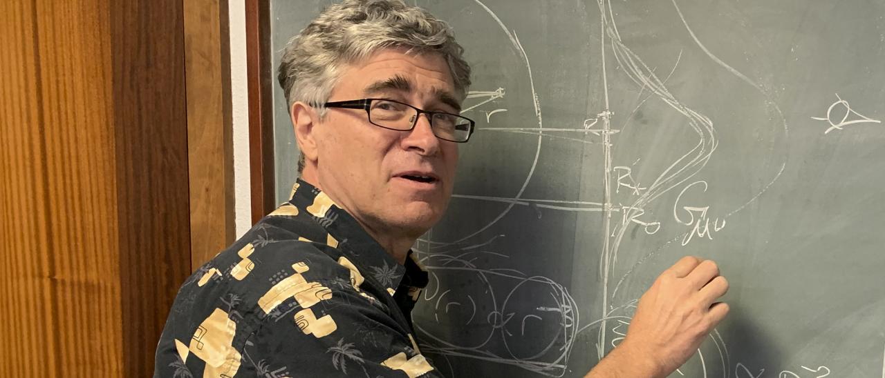 Jeffrey R. Kuhn, writing on a blackboard during his visit the IAC.