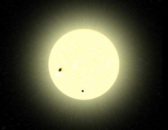 Artistical representation. This image is to scale. Note that the planet is in the lower bottom; the irregular spot in the left of the star is a star-spot. Made by Tautenburg Observatory, Germany.