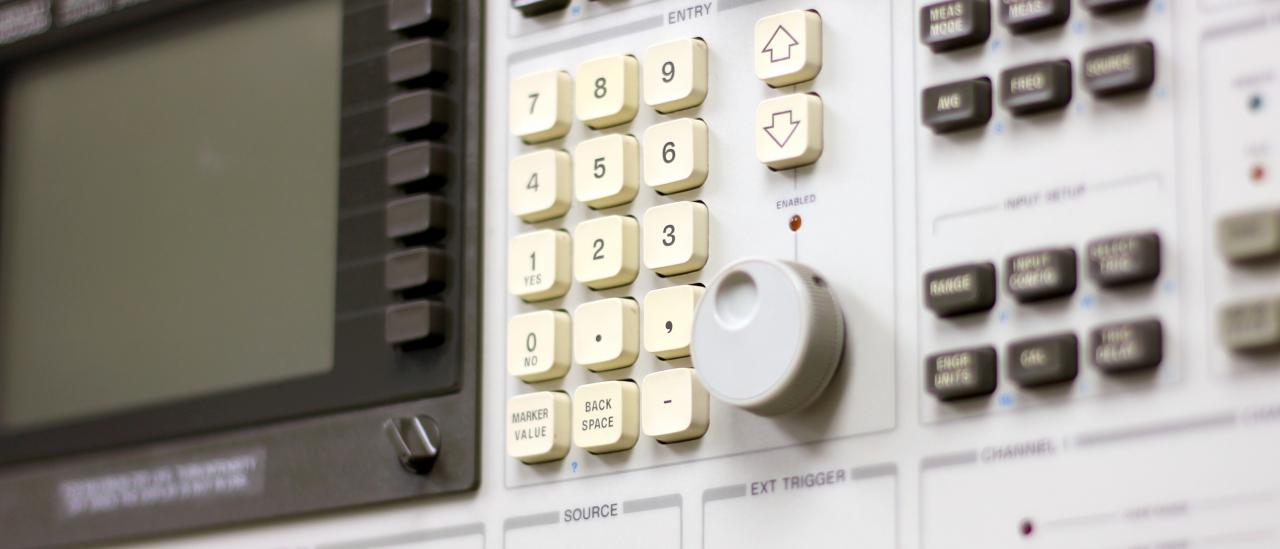 Front view of the control system analyser. Electronic device with a keyboard, buttons and a small screen