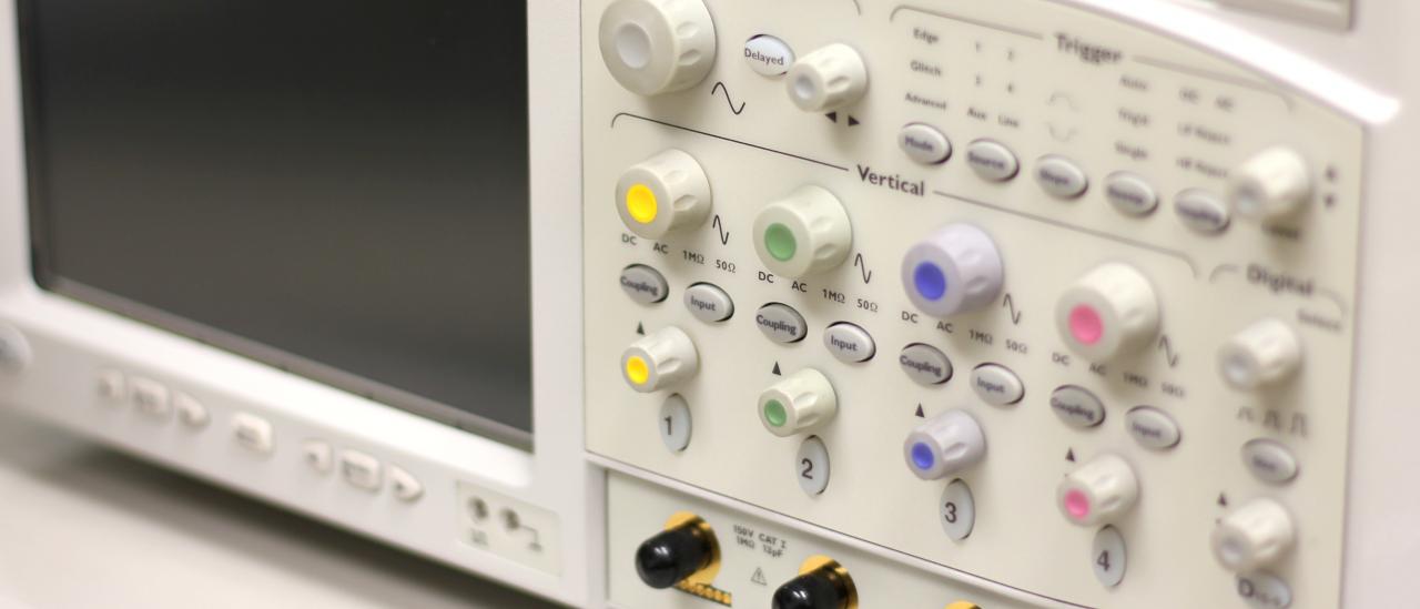 Front view of one of the special featured oscilloscopes. Apparatus with buttons, controls and indicators of different colors and a small monitor