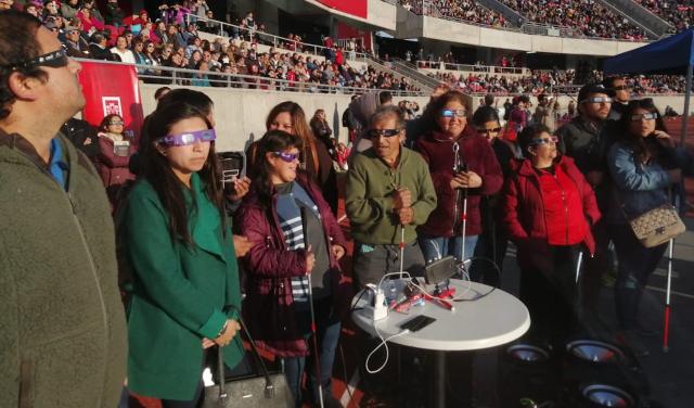 A group of people with visual impairments experiencing a total solar eclipse 