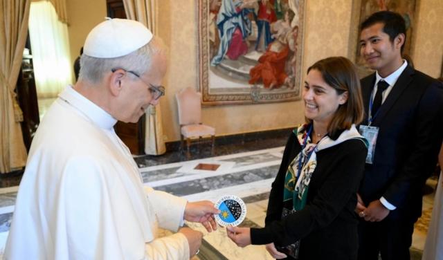 Image of the moment when doctoral students Stella Styliani and Jun-Yan Zhang (Jerry) present Pope Leo XIV with the sticker bearing the IAC logo.
