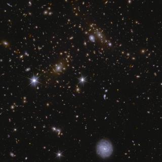 Image of an area of the Euclid Deep Field South showing several huge galactic clusters, as well as intracluster light and gravitational lensing.
