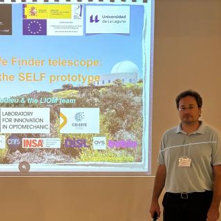 Nicolas Lodieu standing beside the screen during his presentation on the SELF telescope at the CHASES 2026 conference