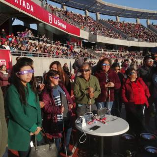 A group of people with visual impairments experiencing a total solar eclipse 
