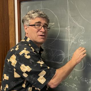 Jeffrey R. Kuhn, from University of Hawaii Jeffrey R. Kuhn, writing on a blackboard at the IAC