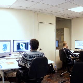 Panoramic view of the CAD studio with engineers working with desktop computers